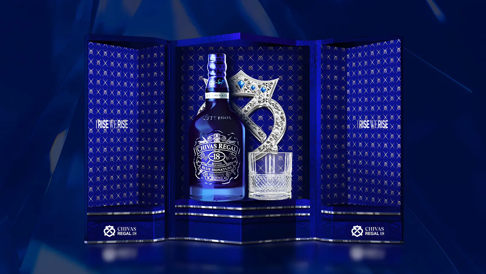 The Blue Signature gift set open, the same crest cut in ice-blue crystal beside the bottle