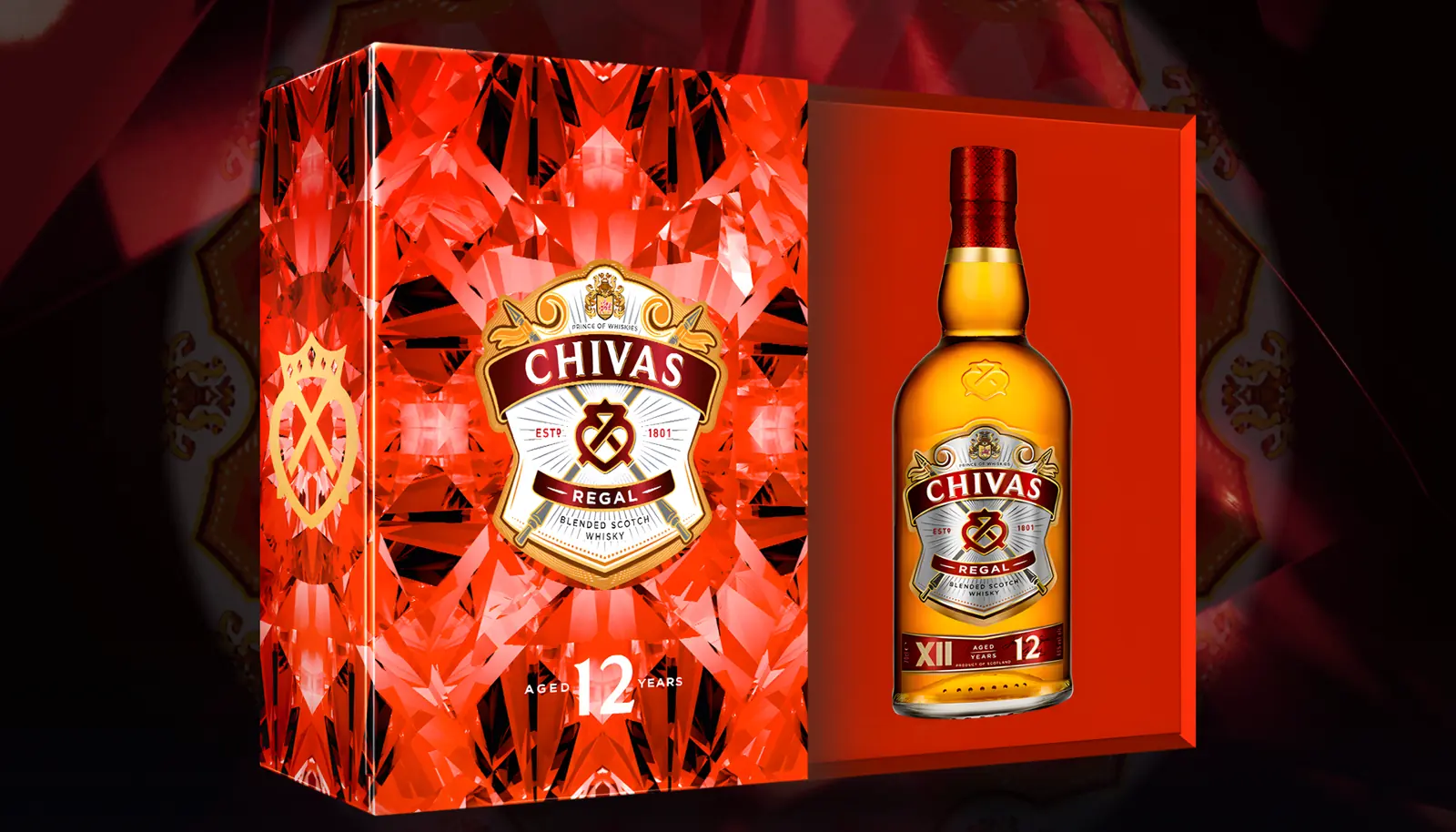 The Chivas Regal 12 Tết 2026 gift pack open beside its bottle, on a ruby kaleidoscope ground